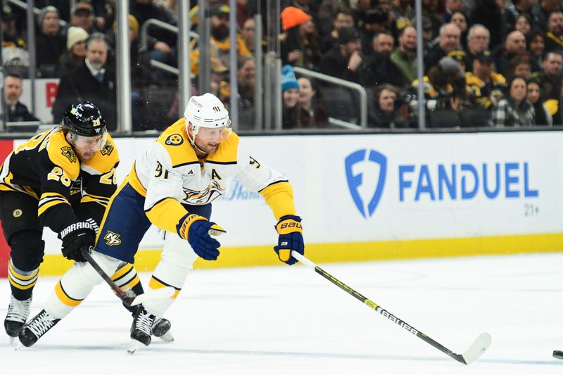 Mar 4, 2025; Boston, Massachusetts, USA;  Nashville Predators center Steven Stamkos (91) reaches for a loose puck ahead of Boston Bruins center Elias Lindholm (28) during the first period at TD Garden. Mandatory Credit: Bob DeChiara-Imagn Images