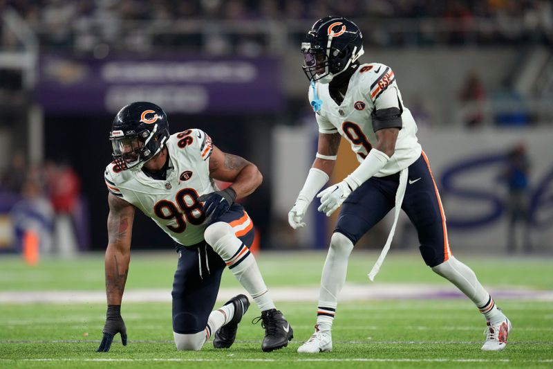 Chicago Bears defensive end Montez Sweat (98) and safety Jaquan Brisker (9) line up for play during the first half of an NFL football game against the Minnesota Vikings, Monday, Nov. 27, 2023, in Minneapolis. (AP Photo/Abbie Parr)