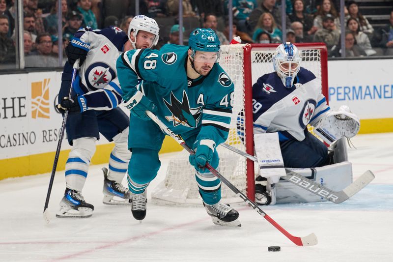 Dec 12, 2023; San Jose, California, USA; San Jose Sharks center Tomas Hertl (48) controls the puck against Winnipeg Jets goaltender Laurent Brossoit (39) during the second period at SAP Center at San Jose. Mandatory Credit: Robert Edwards-USA TODAY Sports