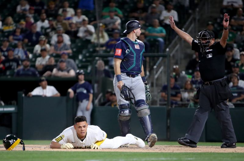 May 5, 2025; West Sacramento, California, USA; Athletics infielder Gio Urshela (13) drops to the ground to avoid being hit by a pitch against the Seattle Mariners during the eleventh inning at Sutter Health Park. Mandatory Credit: Dennis Lee-Imagn Images