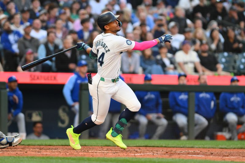May 14, 2024; Seattle, Washington, USA; Seattle Mariners center fielder Julio Rodriguez (44) hits a single against the Kansas City Royals during the sixth inning at T-Mobile Park. Mandatory Credit: Steven Bisig-USA TODAY Sports