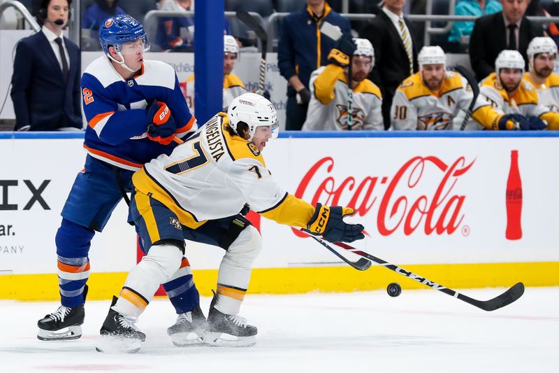 Apr 6, 2024; Elmont, New York, USA; Nashville Predators right wing Luke Evangelista (77) moves the puck past New York Islanders defenseman Mike Reilly (2) during the third period at UBS Arena. Mandatory Credit: Tom Horak-USA TODAY Sports