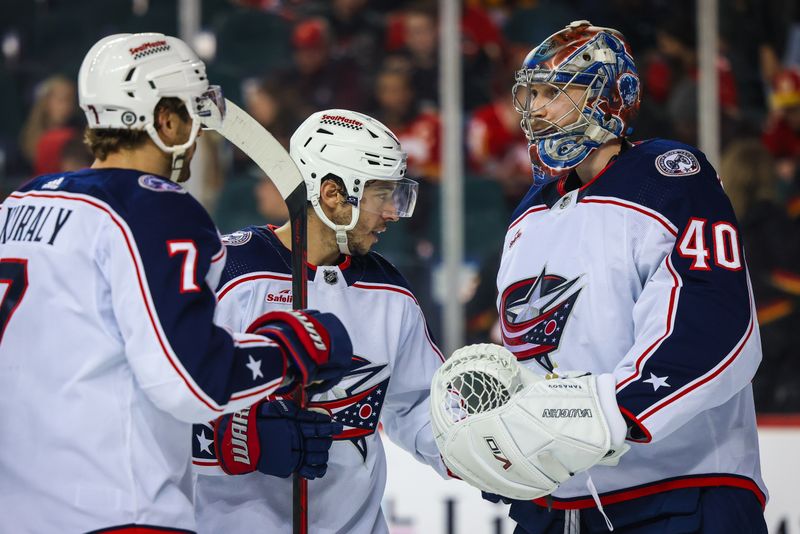 Jan 25, 2024; Calgary, Alberta, CAN; Columbus Blue Jackets goaltender Daniil Tarasov (40) celebrate win with teammates over Calgary Flames at Scotiabank Saddledome. Mandatory Credit: Sergei Belski-USA TODAY Sports