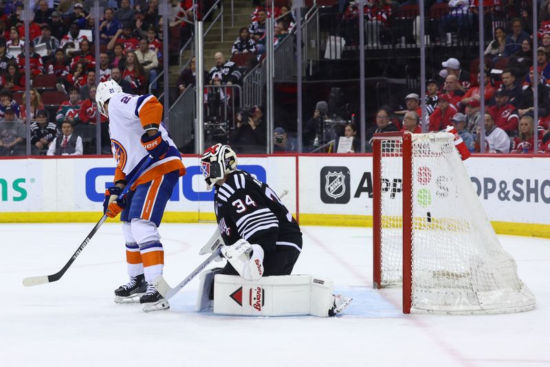 Apr 15, 2024; Newark, New Jersey, USA; New York Islanders center Kyle Palmieri (21) scores a goal on New Jersey Devils goaltender Jake Allen (34) during the first period at Prudential Center. Mandatory Credit: Ed Mulholland-USA TODAY Sports