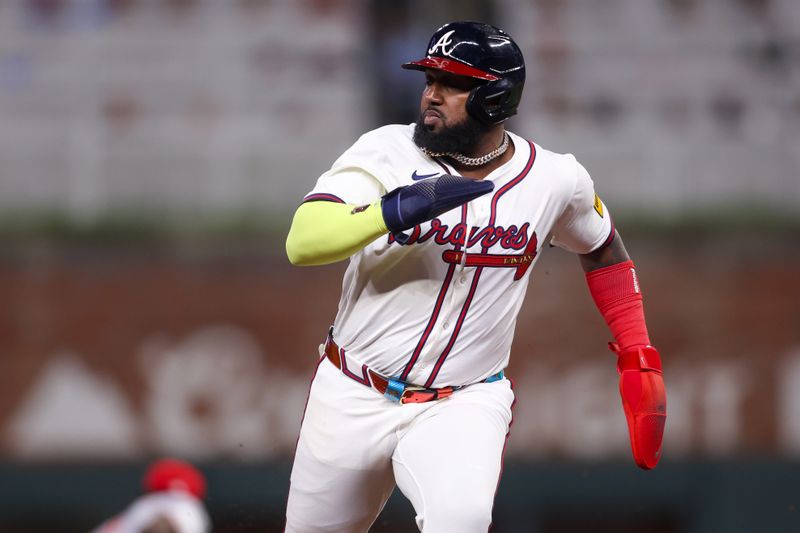 May 7, 2025; Atlanta, Georgia, USA; Atlanta Braves designated hitter Marcell Ozuna (20) runs to third base against the Cincinnati Reds in the sixth inning at Truist Park. Mandatory Credit: Brett Davis-Imagn Images