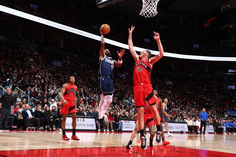 TORONTO, CANADA - FEBRUARY 28: Kyrie Irving #11 of the Dallas Mavericks shoots the ball during the game against the Toronto Raptors on February 28, 2024 at the Scotiabank Arena in Toronto, Ontario, Canada.  NOTE TO USER: User expressly acknowledges and agrees that, by downloading and or using this Photograph, user is consenting to the terms and conditions of the Getty Images License Agreement.  Mandatory Copyright Notice: Copyright 2024 NBAE (Photo by Vaughn Ridley/NBAE via Getty Images)