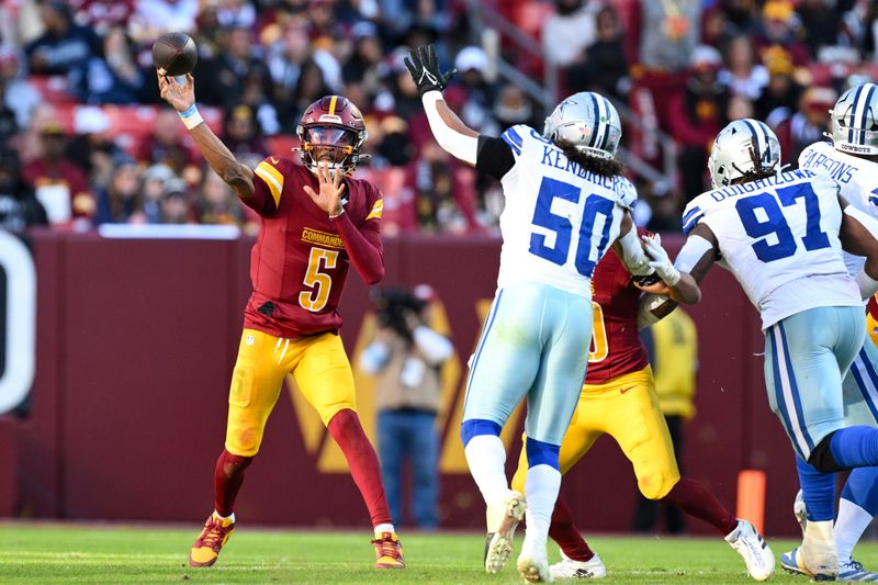 Washington Commanders quarterback Jayden Daniels (5) throws a pass during the second half of an NFL football game against the Dallas Cowboys, Sunday, Nov. 24, 2024, in Landover, Md. (AP Photo/Terrance Williams)