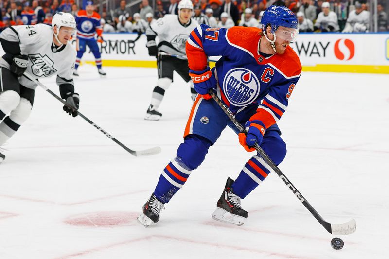 Apr 22, 2024; Edmonton, Alberta, CAN; Edmonton Oilers forward Connor McDavid (97) looks to make a pass in front of Los Angeles Kings defensemen Mikey Anderson (44) during the first period in game one of the first round of the 2024 Stanley Cup Playoffs at Rogers Place. Mandatory Credit: Perry Nelson-USA TODAY Sports