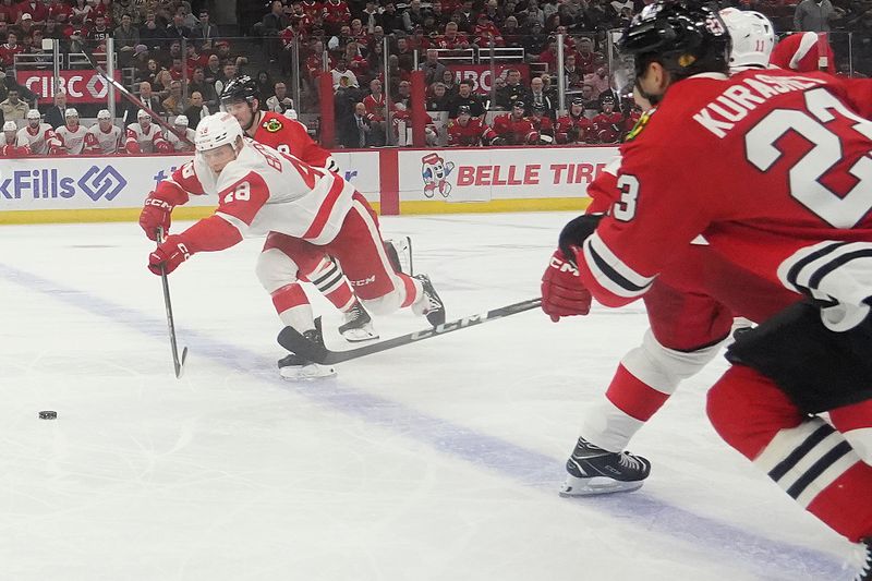 Nov 6, 2024; Chicago, Illinois, USA; Detroit Red Wings right wing Jonatan Berggren (48) moves the puck against the Chicago Blackhawks during the first period at United Center. Mandatory Credit: David Banks-Imagn Images