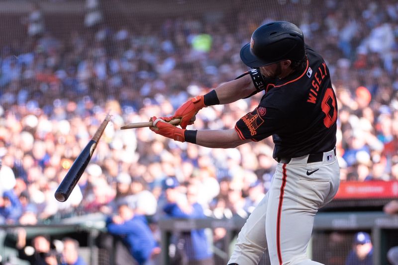 Jun 29, 2024; San Francisco, California, USA; San Francisco Giants second baseman Brett Wisely (0) breaks his bat on a rbi single during the fifth inning of the game against the Los Angeles Dodgers at Oracle Park. Mandatory Credit: Ed Szczepanski-USA TODAY Sports