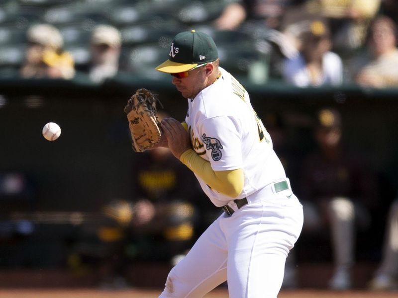 Sep 16, 2023; Oakland, California, USA; Oakland Athletics first baseman Ryan Noda (49) misplays a grounder by San Diego Padres catcher Brett Sullivan during the fifth inning at Oakland-Alameda County Coliseum. Two runs scored when Noda made an errant throw that ended up in the Athletics dugout. Mandatory Credit: D. Ross Cameron-USA TODAY Sports