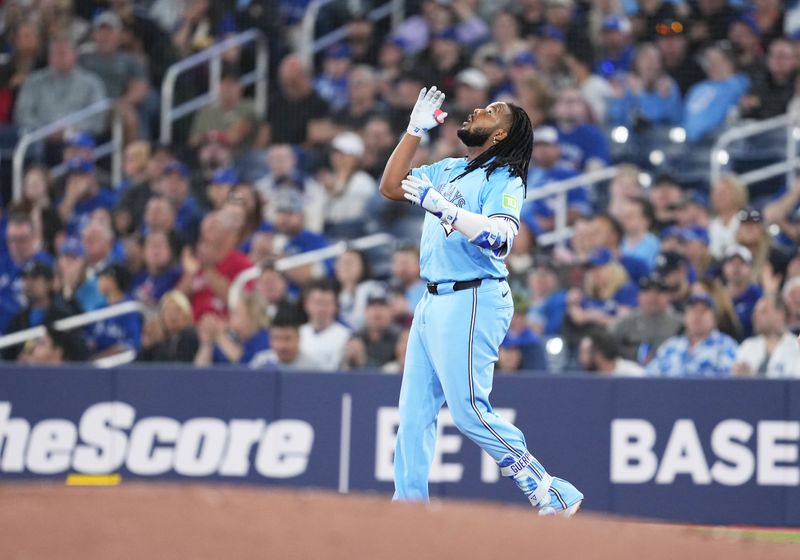 May 11, 2024; Toronto, Ontario, CAN; Toronto Blue Jays first base Vladimir Guerrero Jr. (27) celebrates hitting a single against the Minnesota Twins during the first inning at Rogers Centre. Mandatory Credit: Nick Turchiaro-USA TODAY Sports