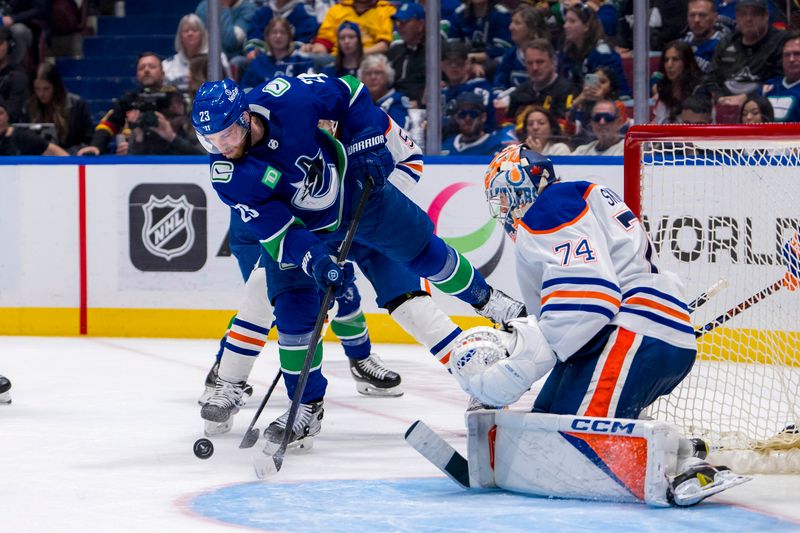 May 20, 2024; Vancouver, British Columbia, CAN; Vancouver Canucks forward Elias Lindholm (23) shoots on Edmonton Oilers goalie Stuart Skinner (74) during the third period in game seven of the second round of the 2024 Stanley Cup Playoffs at Rogers Arena. Mandatory Credit: Bob Frid-USA TODAY Sports