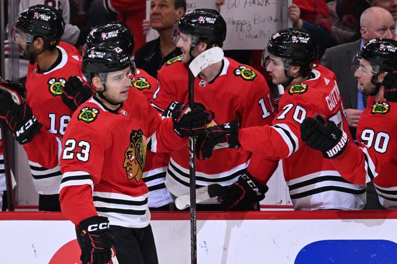 Mar 6, 2023; Chicago, Illinois, USA;  Chicago Blackhawks forward Philipp Kurashev (23) celebrates with the bench after scoring a goal in the first period against the Ottawa Senators at United Center. Mandatory Credit: Jamie Sabau-USA TODAY Sports