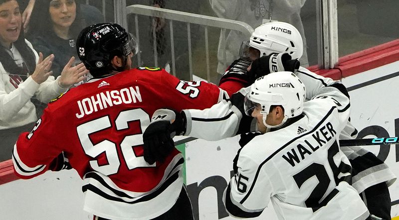 Jan 22, 2023; Chicago, Illinois, USA; Chicago Blackhawks center Reese Johnson (52) and Los Angeles Kings defenseman Tobias Bjornfot (7) skirmish during the first period at United Center. Mandatory Credit: David Banks-USA TODAY Sports