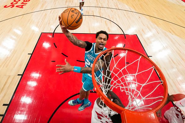 TORONTO, ON - DECEMBER 18: P.J. Washington #25 of the Charlotte Hornets goes to the basket against Pascal Siakam #43 of the Toronto Raptors during first half NBA action at Scotiabank Arena on December 18, 2023 in Toronto, Ontario, Canada. NOTE TO USER: User expressly acknowledges and agrees that, by downloading and/or using this Photograph, user is consenting to the terms and conditions of the Getty Images License Agreement. (Photo by Andrew Lahodynskyj/Getty Images)