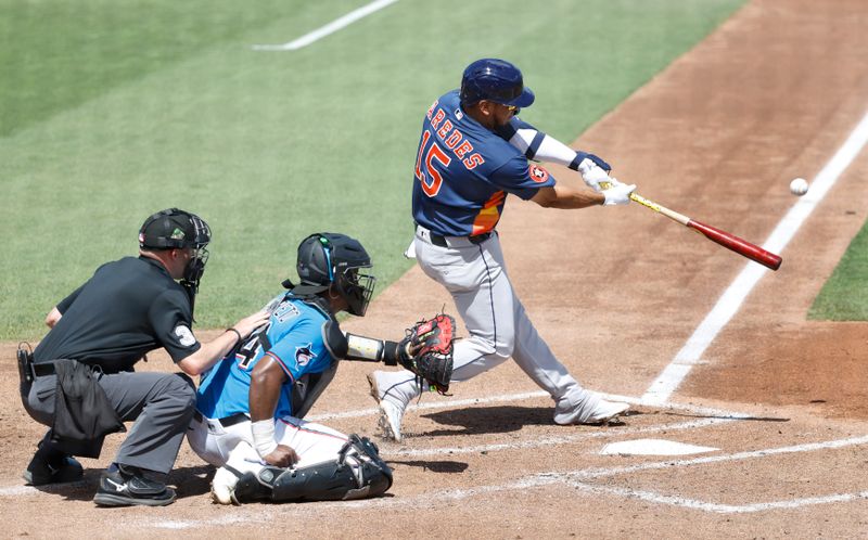 Mar 11, 2026; Jupiter, Florida, USA;  Houston Astros third baseman Isaac Paredes (15) hits a solo home run against the Miami Marlins during the fourth inning at Roger Dean Chevrolet Stadium. Mandatory Credit: Rhona Wise-Imagn Images