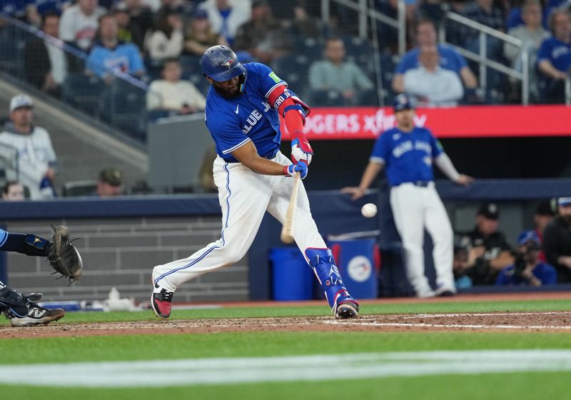 May 13, 2025; Toronto, Ontario, CAN; Toronto Blue Jays first base Vladimir Guerrero Jr. (27) hits an RBI double against the Tampa Bay Rays during the ninth inning at Rogers Centre. Mandatory Credit: Nick Turchiaro-Imagn Images