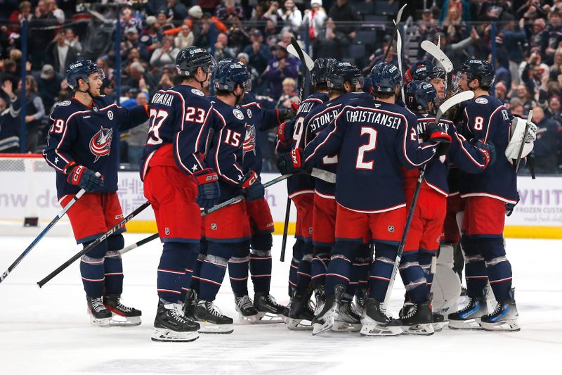 Nov 21, 2024; Columbus, Ohio, USA; Columbus Blue Jackets defenseman Zach Werenski (8) celebrates his game winning goal in overtime against the Tampa Bay Lightning at Nationwide Arena. Mandatory Credit: Russell LaBounty-Imagn Images