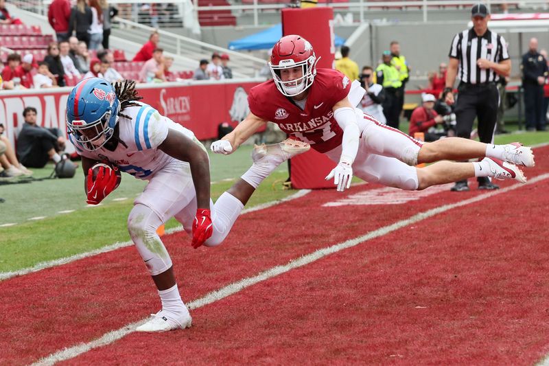 Nov 2, 2024; Fayetteville, Arkansas, USA; Ole Miss Rebels tight end Dae’Quan Wright (8) catches a pass for a touchdown in the fourth quarter as Arkansas Razorbacks defensive back Hudson Clark (17) defends at Donald W. Reynolds Razorback Stadium. Mississippi won 63-31. Mandatory Credit: Nelson Chenault-Imagn Images