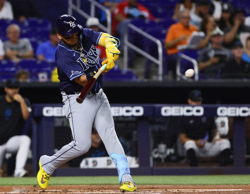 Jun 5, 2024; Miami, Florida, USA; Tampa Bay Rays designated hitter Isaac Paredes (17) hits a two-run double against the Miami Marlins during the first inning at loanDepot Park. Mandatory Credit: Sam Navarro-USA TODAY Sports