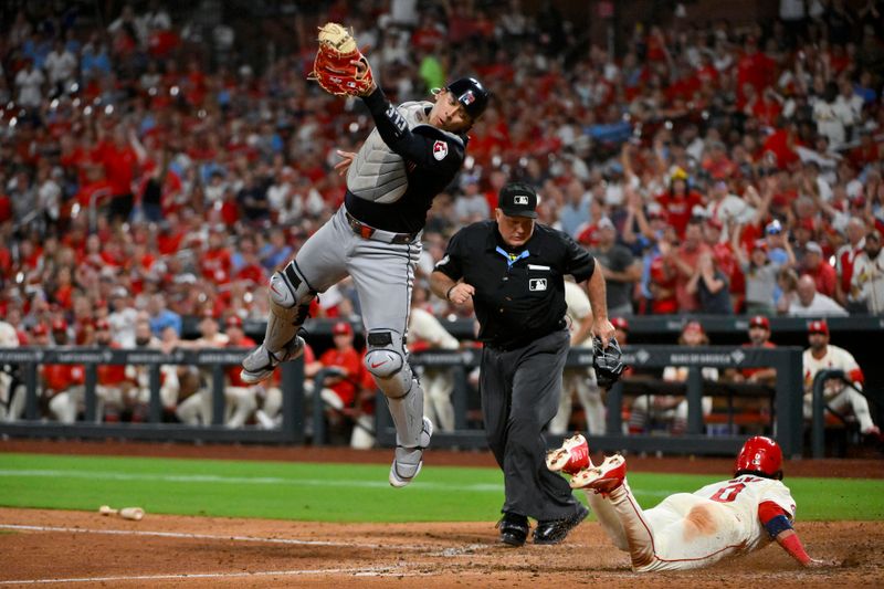 Sep 21, 2024; St. Louis, Missouri, USA;  St. Louis Cardinals shortstop Masyn Winn (0) slides safely past Cleveland Guardians catcher Bo Naylor (23) during the seventh inning at Busch Stadium. Mandatory Credit: Jeff Curry-Imagn Images