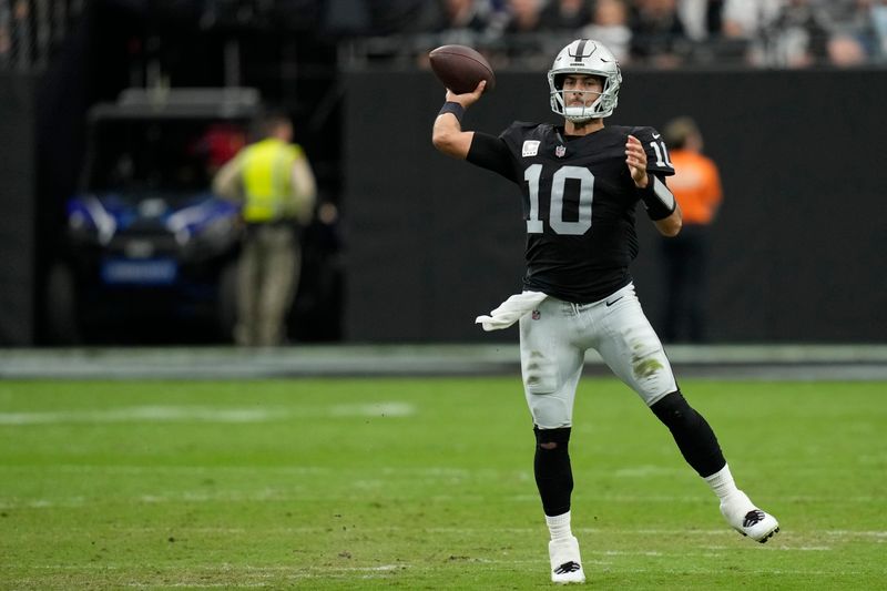 Las Vegas Raiders quarterback Jimmy Garoppolo (10) throws against the New England Patriots during an NFL football game, Sunday, Oct. 15, 2023, in Las Vegas. (AP Photo/John Locher)