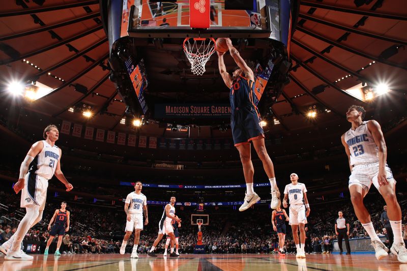 NEW YORK, NY - DECEMBER 3: Jericho Sims #20 of the New York Knicks dunks the ball during the game against the Orlando Magic  during the Emirates NBA Cup on December 3, 2024 at Madison Square Garden in New York City, New York.  NOTE TO USER: User expressly acknowledges and agrees that, by downloading and or using this photograph, User is consenting to the terms and conditions of the Getty Images License Agreement. Mandatory Copyright Notice: Copyright 2024 NBAE  (Photo by Nathaniel S. Butler/NBAE via Getty Images)