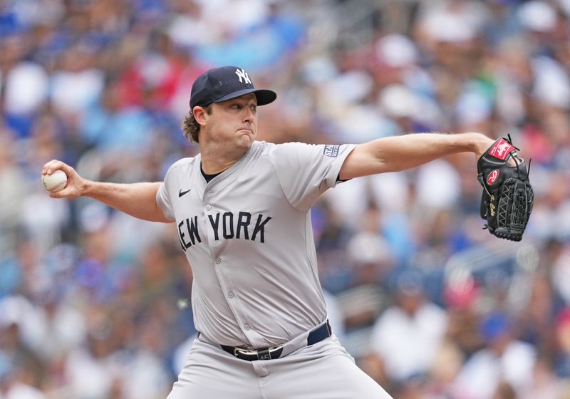 Jun 30, 2024; Toronto, Ontario, CAN; New York Yankees starting pitcher Gerrit Cole (45) throws a pitch against the Toronto Blue Jays during the first inning at Rogers Centre. Mandatory Credit: Nick Turchiaro-USA TODAY Sports