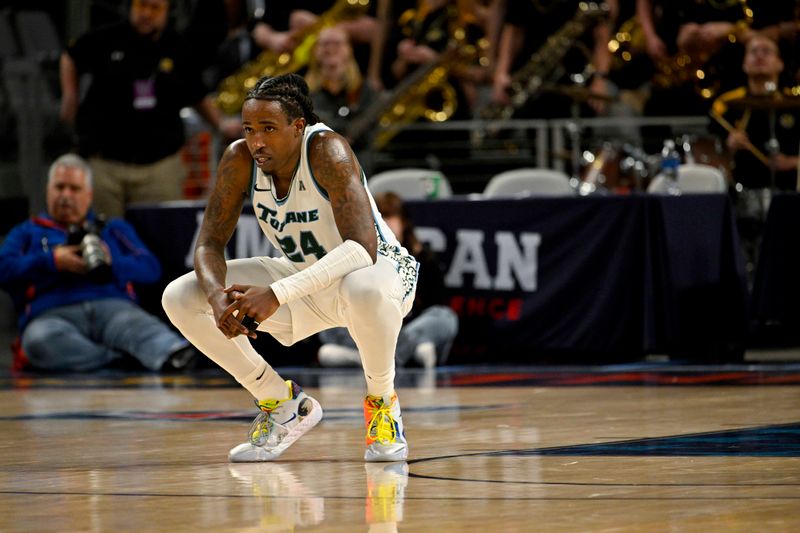 Mar 10, 2023; Fort Worth, TX, USA; Tulane Green Wave forward Kevin Cross (24) kneels on the floor after the win over the Wichita State Shockers at Dickies Arena. Mandatory Credit: Jerome Miron-USA TODAY Sports