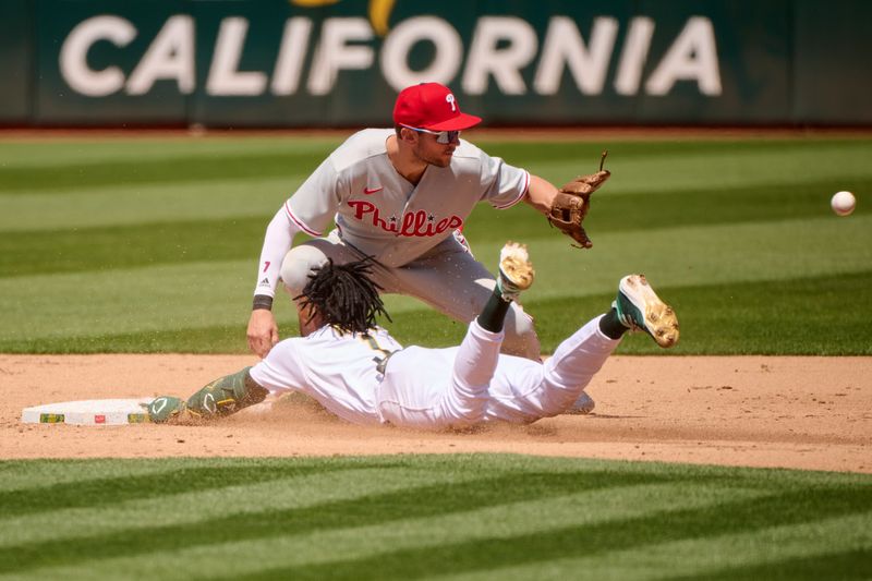 Jun 17, 2023; Oakland, California, USA; Oakland Athletics outfielder Esteury Ruiz (1) slides into second base with a double against Philadelphia Phillies infielder Trea Turner (7) during the sixth inning at Oakland-Alameda County Coliseum. Mandatory Credit: Robert Edwards-USA TODAY Sports