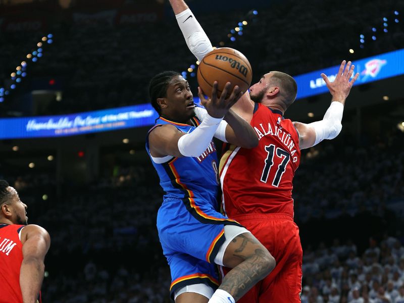 OKLAHOMA CITY, OKLAHOMA - APRIL 24:  Jalen Williams #8 of the Oklahoma City Thunder drives to the basket as Jonas Valanciunas #17 of the New Orleans Pelicans defends during game two of the first round of the NBA playoffs at Paycom Center on April 24, 2024 in Oklahoma City, Oklahoma. (Photo by Jamie Squire/Getty Images)