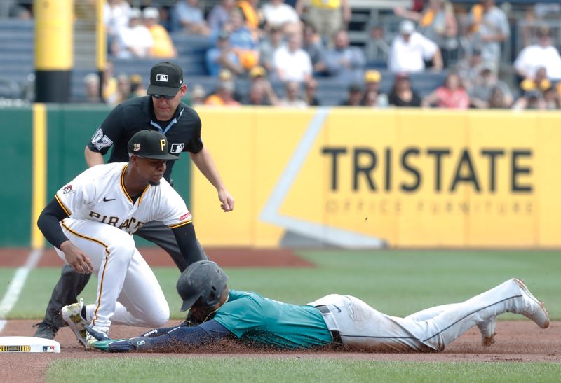 Aug 17, 2024; Pittsburgh, Pennsylvania, USA;  Pittsburgh Pirates third baseman Ke'Bryan Hayes (13) tags Seattle Mariners second baseman Jorge Polanco (right) out at third base on a fielder’s choice putout during the first inning at PNC Park. Mandatory Credit: Charles LeClaire-USA TODAY Sports