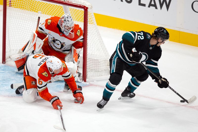 Oct 12, 2024; San Jose, California, USA; San Jose Sharks left winger William Eklund (72) tries to backhand a shot into the goal against Anaheim Ducks goaltender Lukas Dostal (1) and defenseman Brian Dumoulin (6) during the first period at SAP Center at San Jose. Mandatory Credit: D. Ross Cameron-Imagn Images