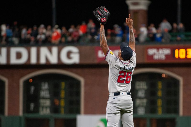 Aug 13, 2024; San Francisco, California, USA;  Atlanta Braves pitcher Raisel Iglesias (26) points to the sky after defeating the San Francisco Giants at Oracle Park. Mandatory Credit: Ed Szczepanski-USA TODAY Sports