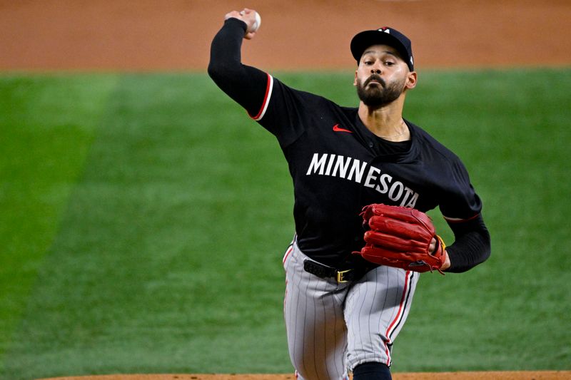 Aug 18, 2024; Arlington, Texas, USA; Minnesota Twins starting pitcher Pablo Lopez (49) pitches against the Texas Rangers during the first inning at Globe Life Field. Mandatory Credit: Jerome Miron-USA TODAY Sports