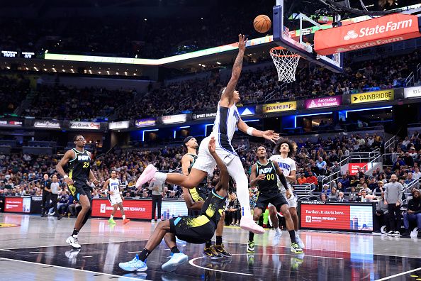 INDIANAPOLIS, INDIANA - DECEMBER 23: Paolo Banchero #5 of the Orlando Magic is fouled by Aaron Nesmith #23 of the Indiana Pacers during the first half at Gainbridge Fieldhouse on December 23, 2023 in Indianapolis, Indiana. NOTE TO USER: User expressly acknowledges and agrees that, by downloading and or using this photograph, User is consenting to the terms and conditions of the Getty Images License Agreement. (Photo by Justin Casterline/Getty Images)