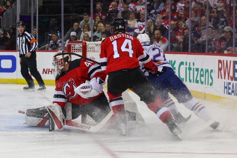 Dec 21, 2023; Newark, New Jersey, USA; Edmonton Oilers left wing Adam Erne (21) scores a goal on New Jersey Devils goaltender Vitek Vanecek (41) during the third period at Prudential Center. Mandatory Credit: Ed Mulholland-USA TODAY Sports