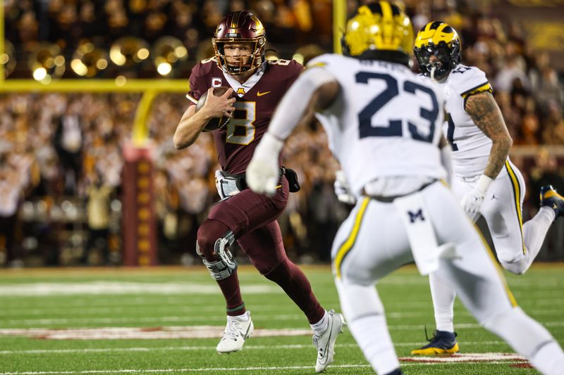 Oct 7, 2023; Minneapolis, Minnesota, USA; Minnesota Golden Gophers quarterback Athan Kaliakmanis (8) runs the ball against the Michigan Wolverines during the first quarter at Huntington Bank Stadium. Mandatory Credit: Matt Krohn-USA TODAY Sports