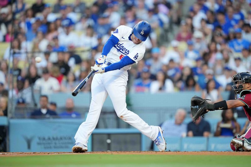 Jul 3, 2024; Los Angeles, California, USA; Los Angeles Dodgers first baseman Freddie Freeman (5) hits a three-run home run in the first inning against the Arizona Diamondbacks at Dodger Stadium. Mandatory Credit: Kirby Lee-USA TODAY Sports