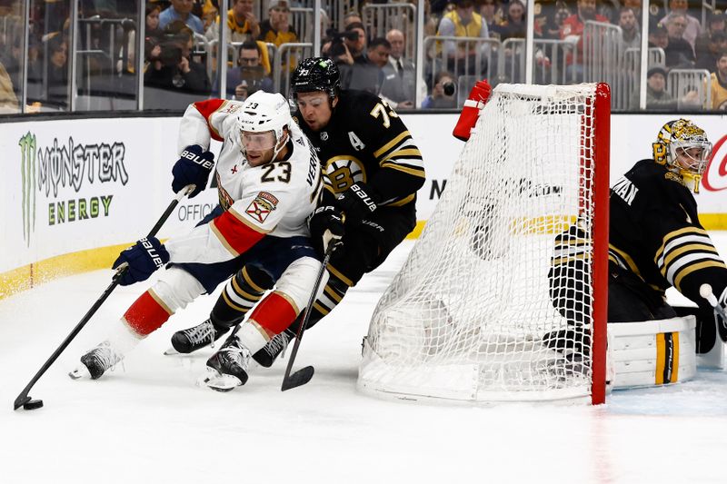 May 10, 2024; Boston, Massachusetts, USA; Florida Panthers center Carter Verhaeghe (23) wheels behind the net with Boston Bruins defenseman Charlie McAvoy (73) trying to cut him off during the second period of game three of the second round of the 2024 Stanley Cup Playoffs at TD Garden. Mandatory Credit: Winslow Townson-USA TODAY Sports