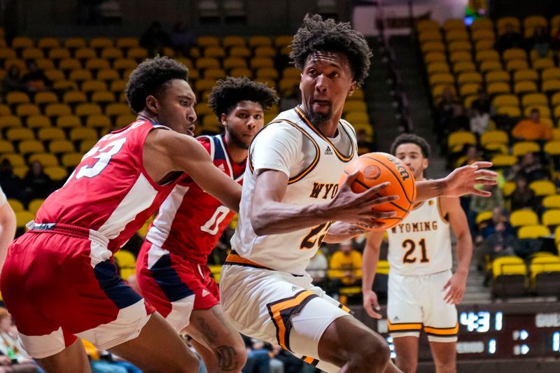 Jan 31, 2023; Laramie, Wyoming, USA; Wyoming Cowboys forward Jeremiah Oden (25) drives against Fresno State Bulldogs guard Leo Colimerio (23) during the first half at Arena-Auditorium. Mandatory Credit: Troy Babbitt-USA TODAY Sports