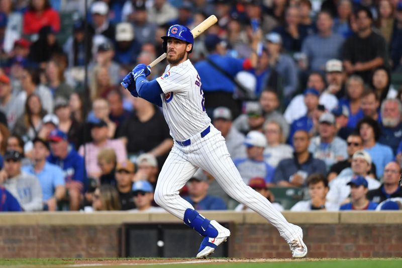 Aug 20, 2024; Chicago, Illinois, USA; Chicago Cubs right fielder Cody Bellinger (24) hits a single during the first inning against the Detroit Tigers at Wrigley Field. Mandatory Credit: Patrick Gorski-USA TODAY Sports
