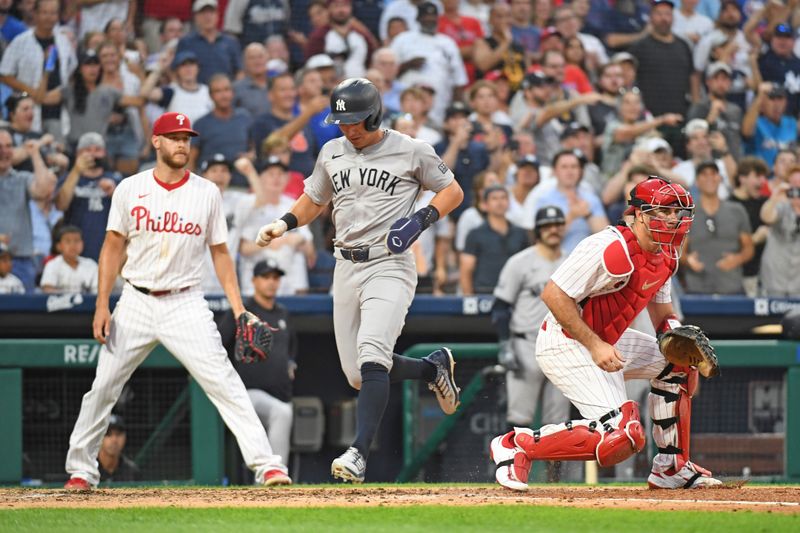 Jul 29, 2024; Philadelphia, Pennsylvania, USA; New York Yankees shortstop Anthony Volpe (11) scores a run as Philadelphia Phillies catcher J.T. Realmuto (10) waits for the throw during the fifth inning at Citizens Bank Park. Mandatory Credit: Eric Hartline-USA TODAY Sports