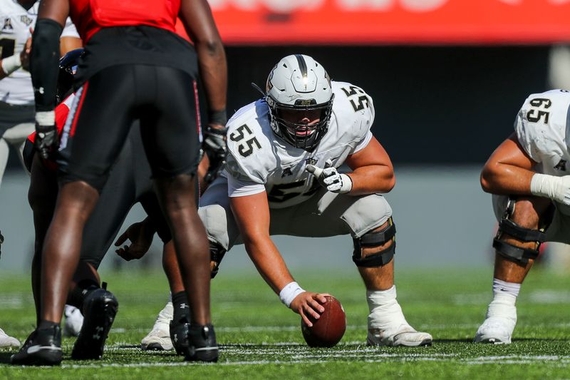 Oct 16, 2021; Cincinnati, Ohio, USA; UCF Knights offensive lineman Matthew Lee (55) snaps the ball against the Cincinnati Bearcats in the second half at Nippert Stadium. Mandatory Credit: Katie Stratman-USA TODAY Sports