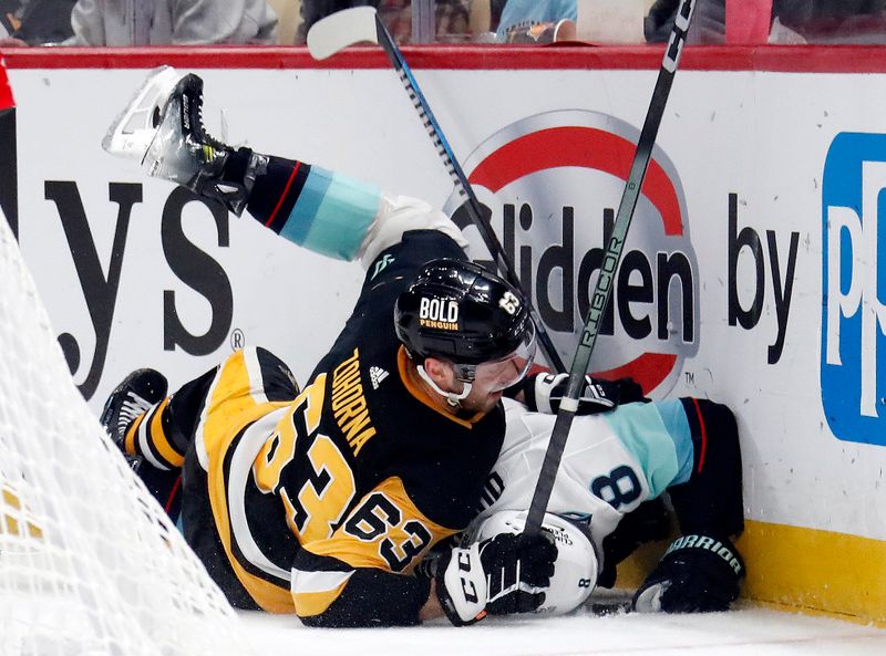 Jan 15, 2024; Pittsburgh, Pennsylvania, USA; Pittsburgh Penguins left wing Radim Zohorna (63) checks Seattle Kraken defenseman Brian Dumoulin (8) during the third period at PPG Paints Arena. Mandatory Credit: Charles LeClaire-USA TODAY Sports