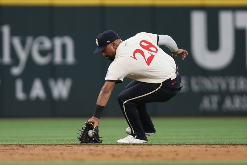 Aug 30, 2024; Arlington, Texas, USA; Texas Rangers shortstop Ezequiel Duran (20) fields a ground ball against the Oakland Athletics in the third inning at Globe Life Field. Mandatory Credit: Tim Heitman-USA TODAY Sports