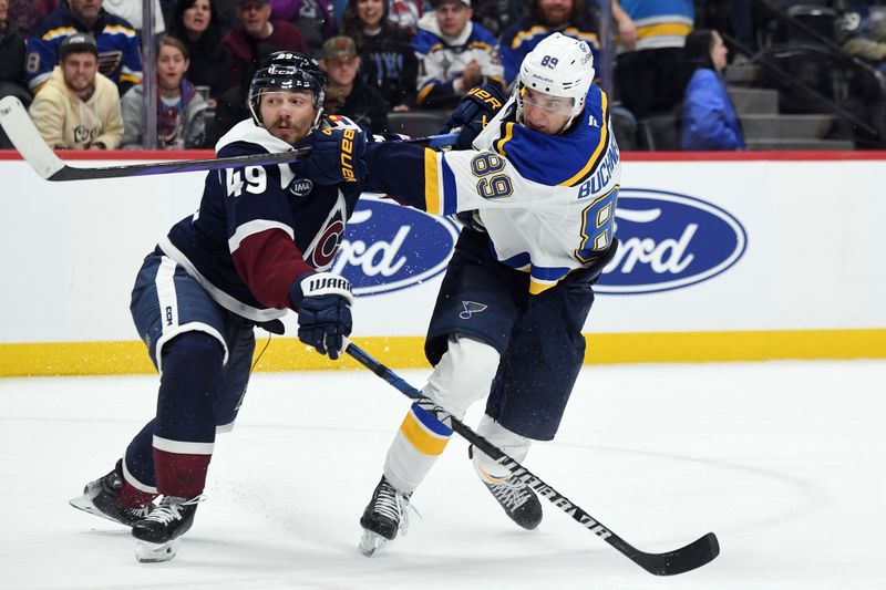 Jan 31, 2025; Denver, Colorado, USA; St. Louis Blues left wing Pavel Buchnevich (89) shoots the puck against Colorado Avalanche defenseman Samuel Girard (49) during the first period at Ball Arena. Mandatory Credit: Christopher Hanewinckel-Imagn Images