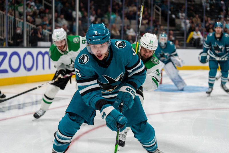 Jan 18, 2023; San Jose, California, USA;  San Jose Sharks defenseman Matt Benning (5) controls the puck against Dallas Stars left wing Jamie Benn (14) during the third period at SAP Center at San Jose. Mandatory Credit: Neville E. Guard-USA TODAY Sports