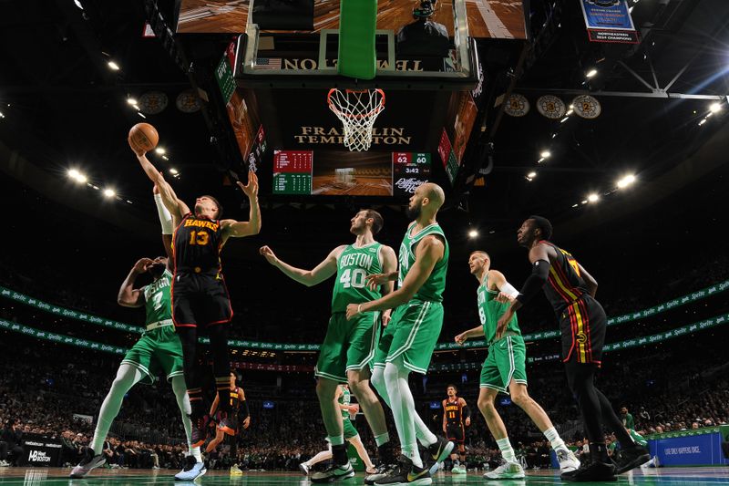 BOSTON, MA - FEBRUARY 7: Bogdan Bogdanovic #13 of the Atlanta Hawks rebounds the ball during the game against the Boston Celtics on February 7, 2024 at the TD Garden in Boston, Massachusetts. NOTE TO USER: User expressly acknowledges and agrees that, by downloading and or using this photograph, User is consenting to the terms and conditions of the Getty Images License Agreement. Mandatory Copyright Notice: Copyright 2024 NBAE  (Photo by Brian Babineau/NBAE via Getty Images)